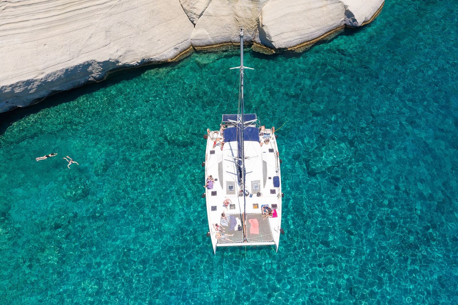 Aerial view of a sailing catamaran at Kleftiko, Milos