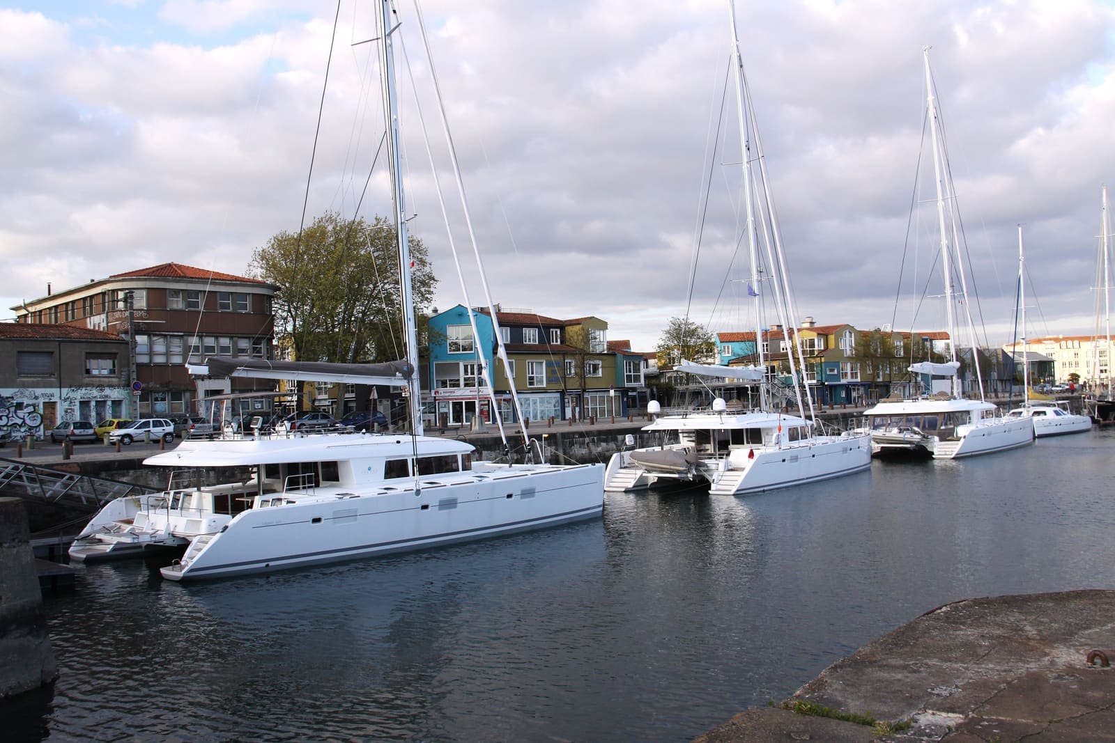 Mar Alto — Lagoon cruising catamarans moored side by side in a harbour