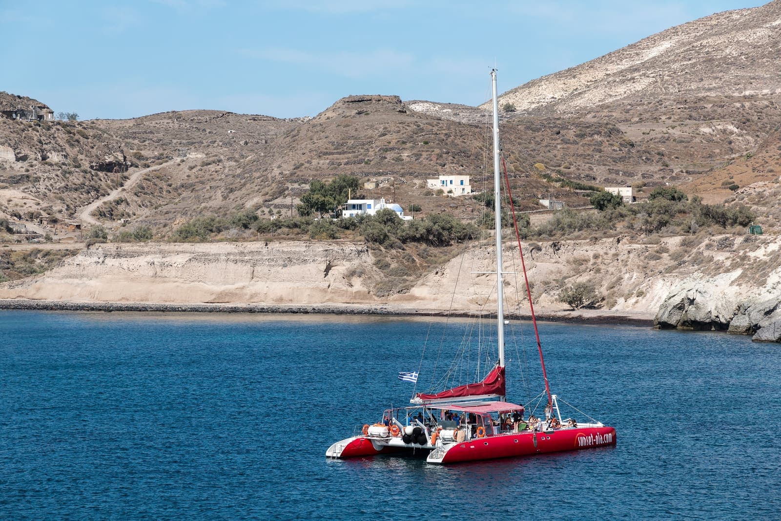 Sea Grape — Catamaran anchored below the cliffs of Akrotiri, Santorini