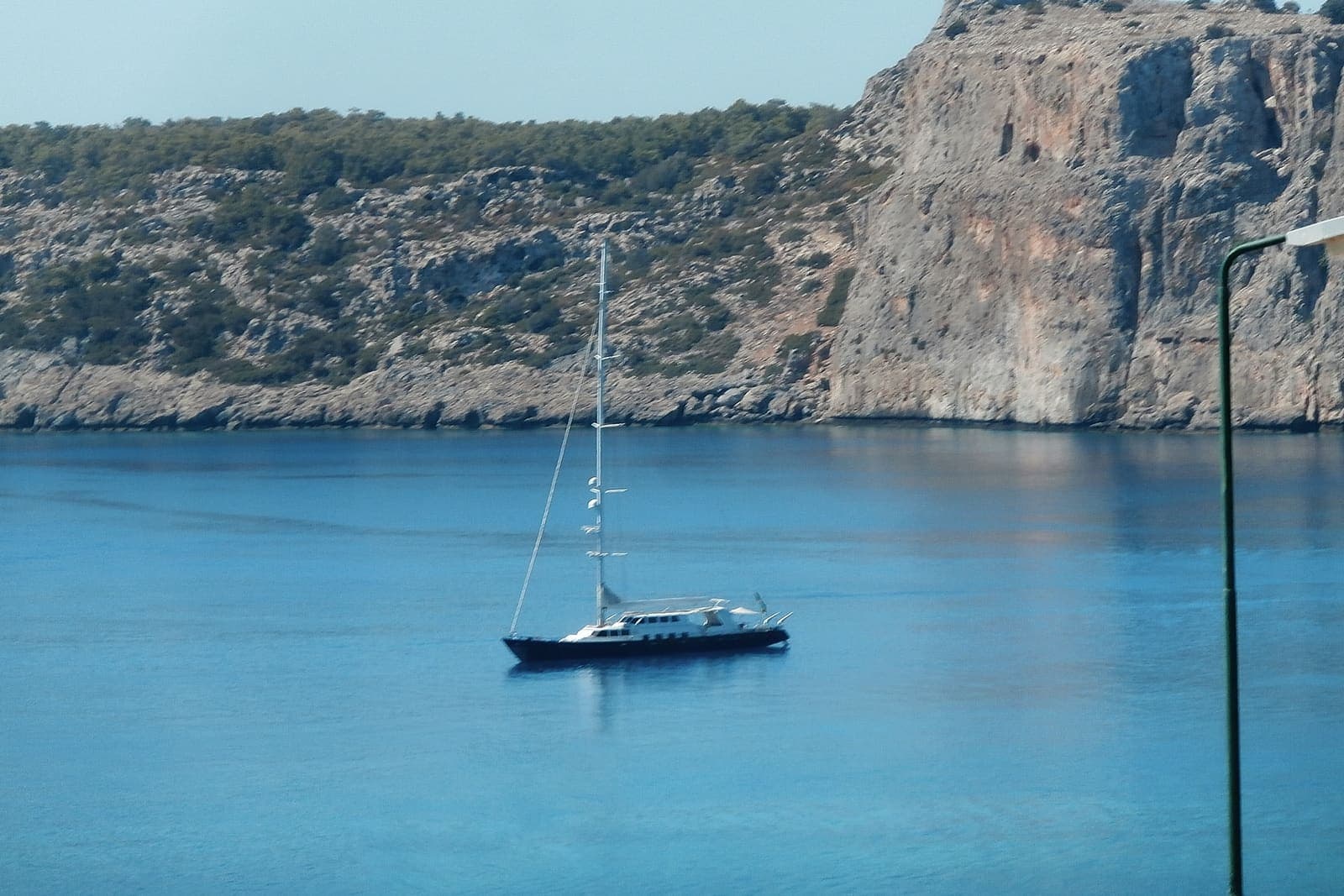 More — Sailing yacht anchored in a turquoise bay near Lindos, Rhodes
