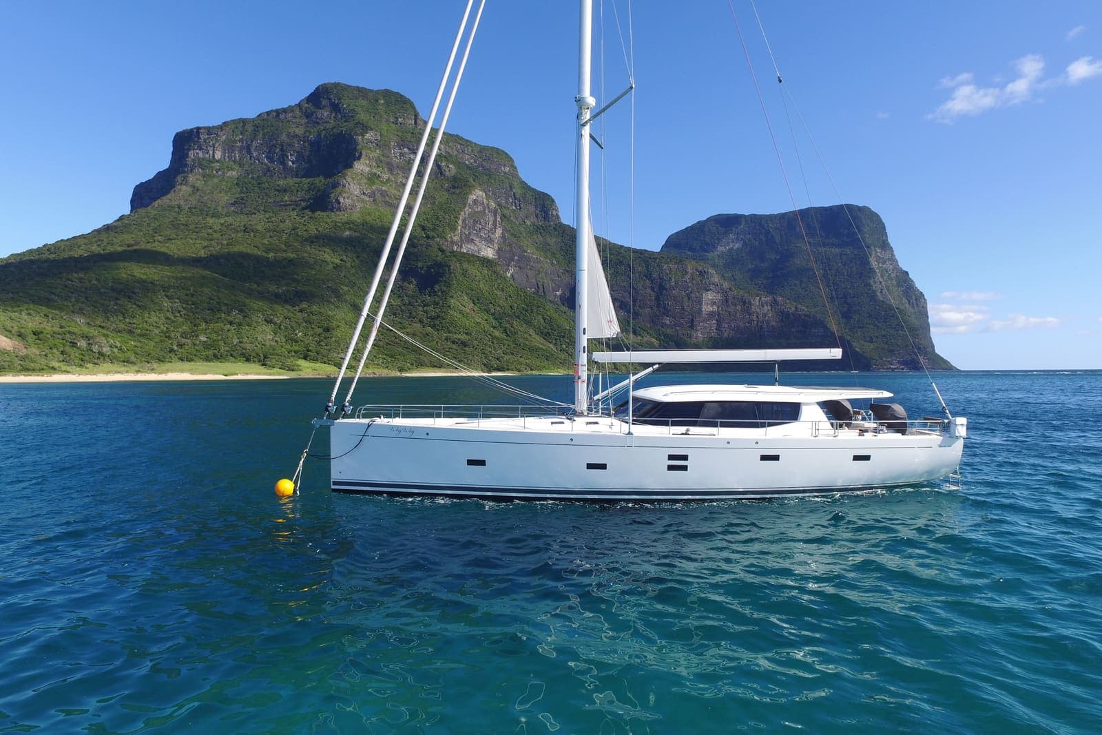 Thetis — Moody DS 54 deck-saloon sailing yacht moored off a mountainous island